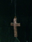 dark background with a cross hanging in the foreground